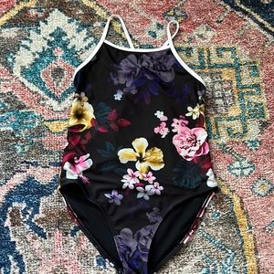 Black floral swimsuit with long sleeve zip up top.